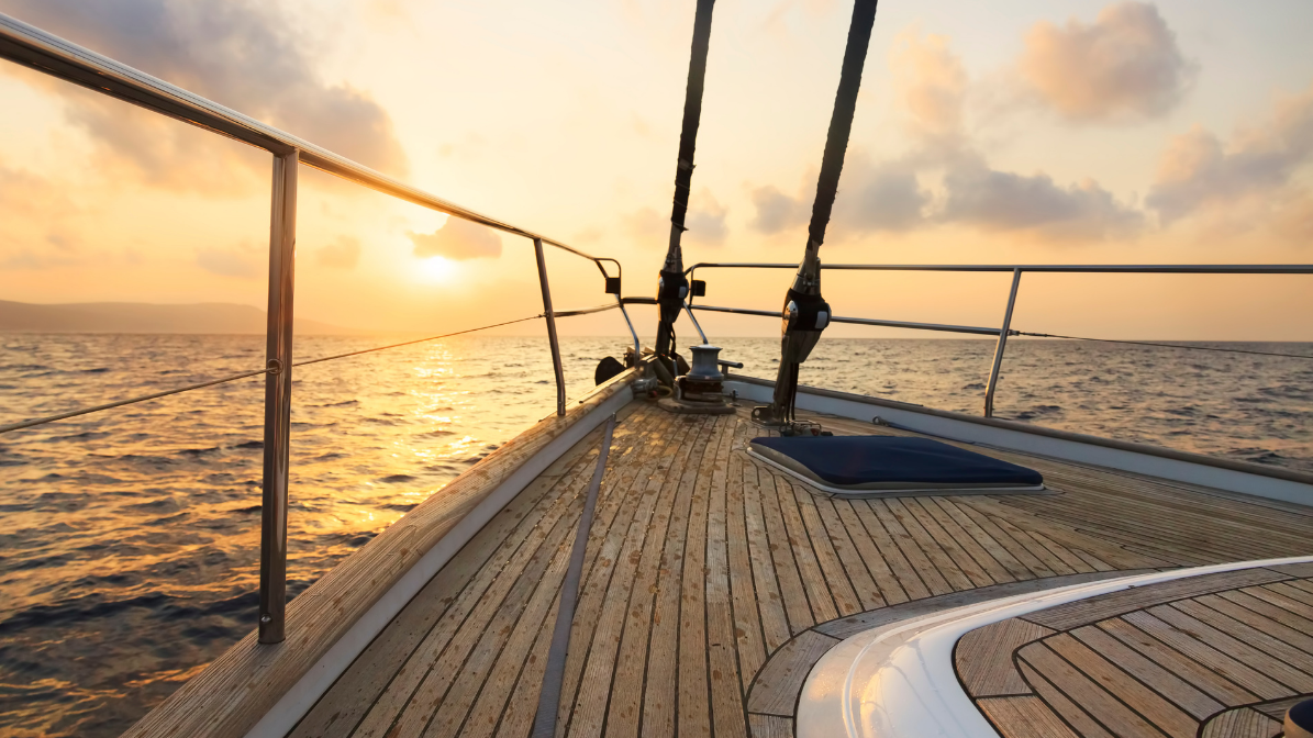Luxury boat deck with Indonesian Teakwood marine decking, resistant to extreme sea conditions and aesthetically pleasing at sunset.